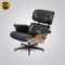 Side profile of the Eames lounge chair replica showing the ergonomic design and ash wood shell.