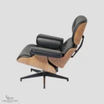 Rear perspective of a Charles Ray Eames lounge chair showing the natural ash wood veneer and aluminum supports.