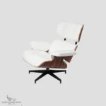 Perspective view of white leather eames lounge chair and ottoman with natural rosewood grain.