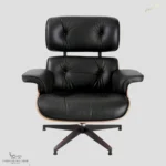 Close-up of Eames chair replica with black top-grain leather upholstery.
