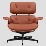 Close-up of the natural tan brown aniline leather upholstery on an Eames lounge chair reproduction.