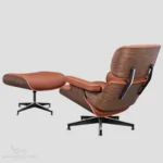 Close-up of the professional black aluminum base of a tan brown Eames lounge chair reproduction.