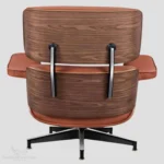 Angled view of a tan brown walnut wood Eames lounge chair reproduction by Eman Fatima.