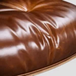 Side rear view highlighting the extended walnut shell of the tall XL eames lounge chair in vintage tan.